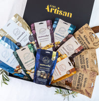 Kiwi Artisam Gourmet Nut Gift Box -  Assorted nut packages from various brands in front of a Kiwi Artisan box.