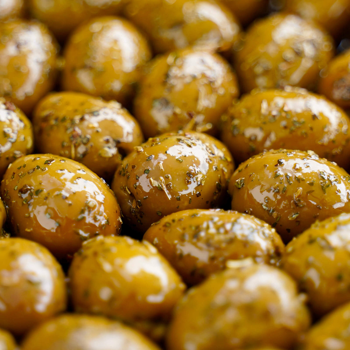 Close-up of marinated olives with a glossy surface