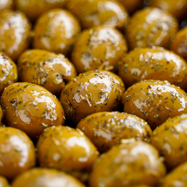 Close-up of marinated olives with a glossy surface