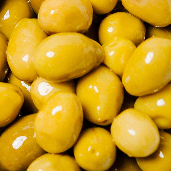 Close-up of yellow olives with a glossy texture